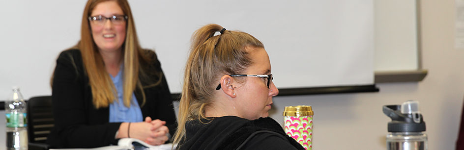 Students listening to instructor in class